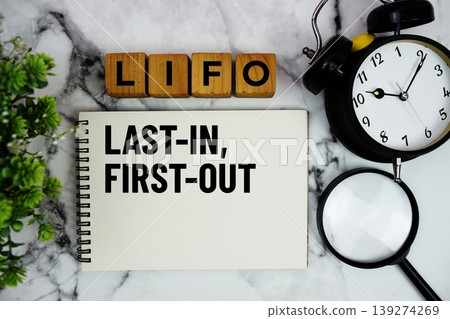 LIFO Last In, First Out text with alarm clock and magnifying glass on marble background 139274269