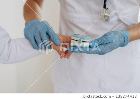 Finger is in oxygen content meter. Detailed close up view of boy with appointment in hospital with doctor 139274418