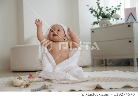 Playful happy little baby is at home in domestic room Playful happy little baby is at home in domestic room 139274570
