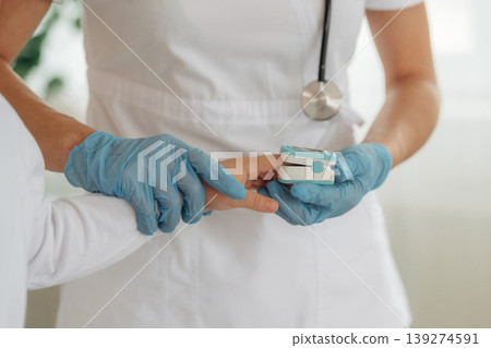 Finger is in oxygen content meter. Detailed close up view of boy with appointment in hospital with doctor Finger is in oxygen content meter. Detailed close up view of boy with appointment in hospital with doctor 139274591