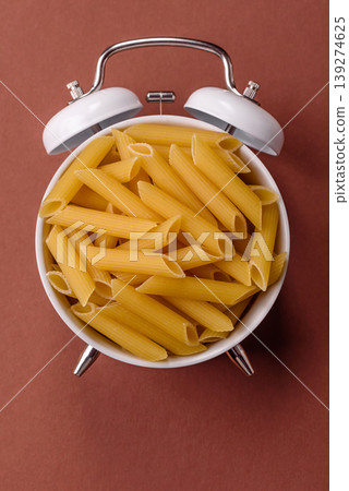 Italian uncooked dry penne regate pasta ready for cooking. Dry penne pasta 139274625