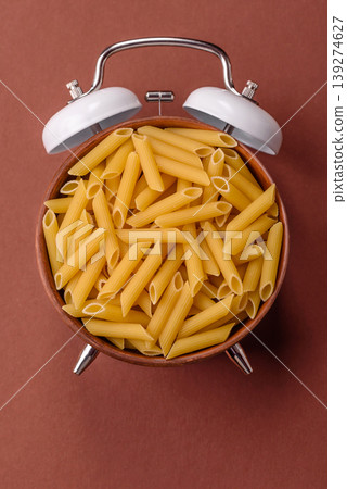 Italian uncooked dry penne regate pasta ready for cooking. Dry penne pasta Italian uncooked dry penne regate pasta ready for cooking. Dry penne pasta 139274627