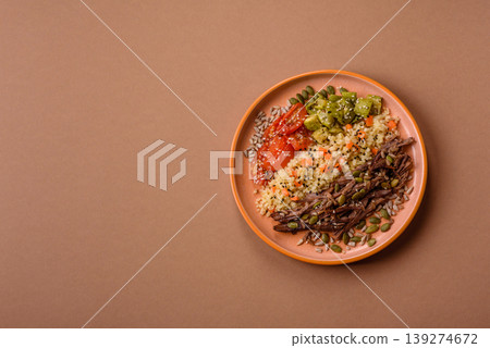 A bowl with beef, porridge, mushrooms, vegetables, sauce, and spices. Beef bowl 139274672