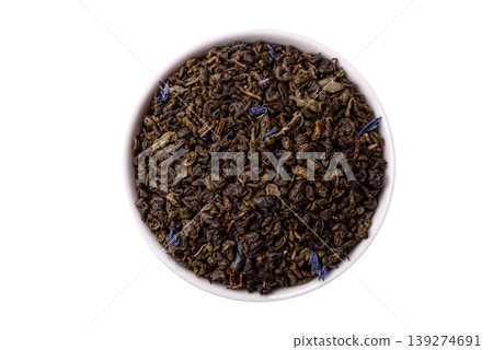 Granules of dried organic Chinese green tea with herbal additives. Dry green tea Granules of dried organic Chinese green tea with herbal additives. Dry green tea 139274691