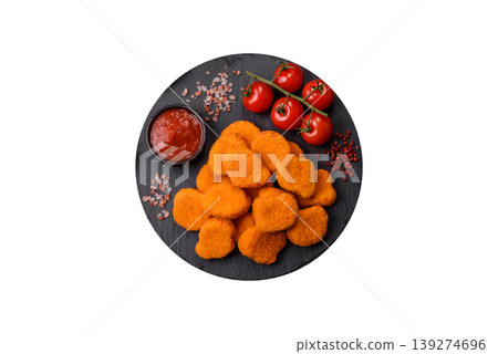 Fried chicken nuggets with sauce, salt, and spices, fast food, unhealthy food. Chicken nuggets 139274696