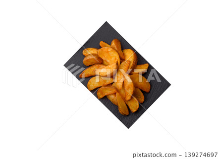 Potato wedges baked with garlic, herbs, and spices for lunch. Potato wedges Potato wedges baked with garlic, herbs, and spices for lunch. Potato wedges 139274697
