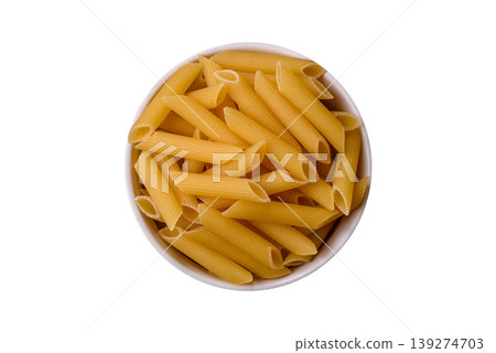 Italian uncooked dry penne regate pasta ready for cooking. Dry penne pasta Italian uncooked dry penne regate pasta ready for cooking. Dry penne pasta 139274703