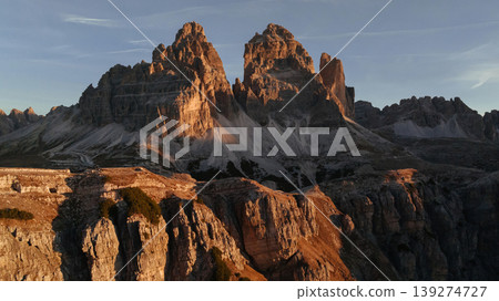 The sunlight covers the rocks. Tre Cime di Lavaredo mountains, majestic view of the popular place, nature background The sunlight covers the rocks. Tre Cime di Lavaredo mountains, majestic view of the popular place, nature background 139274727