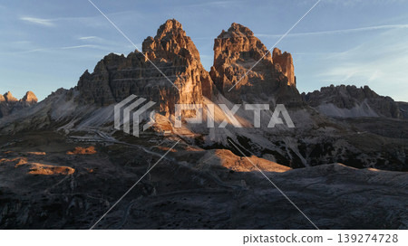 The sunlight covers the rocks. Tre Cime di Lavaredo mountains, majestic view of the popular place, nature background The sunlight covers the rocks. Tre Cime di Lavaredo mountains, majestic view of the popular place, nature background 139274728