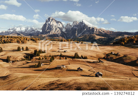 Place to live peaceful life, wooden houses. Alpe di Siusi, Seiser Alm, aerial view of majestic dolomites, mountains background Place to live peaceful life, wooden houses. Alpe di Siusi, Seiser Alm, aerial view of majestic dolomites, mountains background 139274812