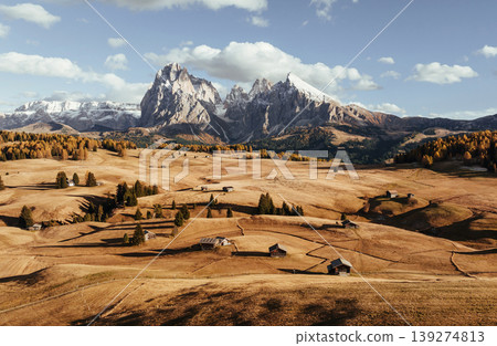 Place to live peaceful life, wooden houses. Alpe di Siusi, Seiser Alm, aerial view of majestic dolomites, mountains background Place to live peaceful life, wooden houses. Alpe di Siusi, Seiser Alm, aerial view of majestic dolomites, mountains background 139274813