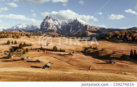 Place to live peaceful life, wooden houses. Alpe di Siusi, Seiser Alm, aerial view of majestic dolomites, mountains background Place to live peaceful life, wooden houses. Alpe di Siusi, Seiser Alm, aerial view of majestic dolomites, mountains background 139274814
