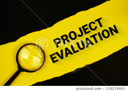Project Evaluation text on yellow with black paper torn ripped and magnifying glass Project Evaluation text on yellow with black paper torn ripped and magnifying glass 139274901