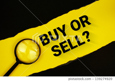 Buy Or Sell? text on yellow with black paper torn ripped and magnifying glass Buy Or Sell? text on yellow with black paper torn ripped and magnifying glass 139274920