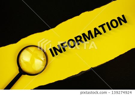 Information text on yellow with black paper torn ripped and magnifying glass 139274924