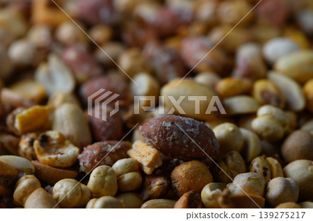 Mixed nuts spread across a rustic wooden surface inviting a sensory experience of textures and flavors Mixed nuts spread across a rustic wooden surface inviting a sensory experience of textures and flavors 139275217