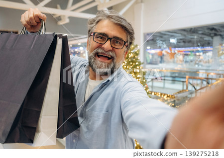 Happy facial expression, with packages. Senior man is in the mall, shopping time conception 139275218