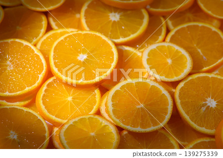 Vibrant orange slices arranged artfully on a market table create a stunning display of freshness and color Vibrant orange slices arranged artfully on a market table create a stunning display of freshness and color 139275339