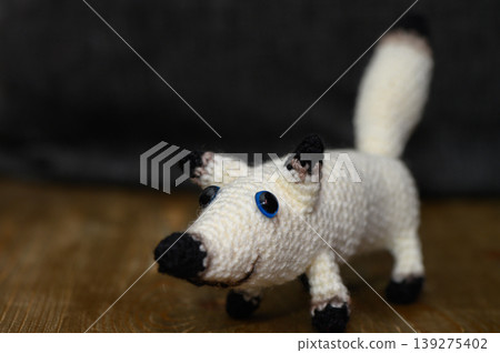 Handcrafted White Knitted Dog on Dark Background 139275402