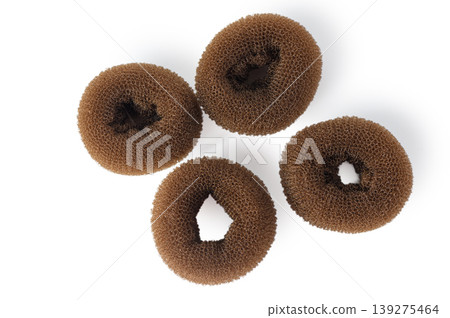 Set of Four Brown Hair Bun Maker Donut Sponges Isolated on White Background Set of Four Brown Hair Bun Maker Donut Sponges Isolated on White Background 139275464