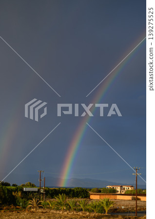 A vibrant rainbow arcs over lush landscape after rain, illuminated by the soft glow of late afternoon sun A vibrant rainbow arcs over lush landscape after rain, illuminated by the soft glow of late afternoon sun 139275525