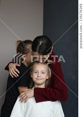 Cheerful young mother hug cuddle children, family bonding concept Cheerful young mother hug cuddle children, family bonding concept 139276269