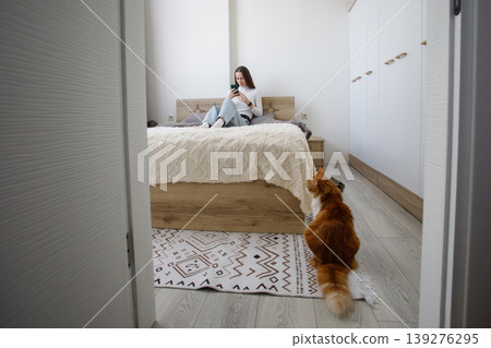Cute woman using smartphone at home 139276295
