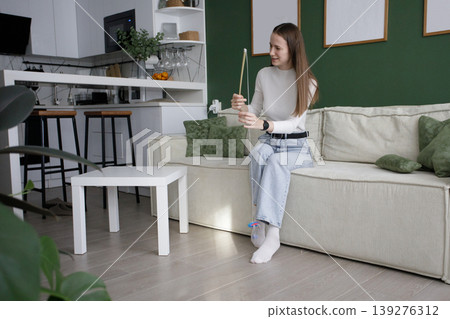 Woman holding toy cat wand stick ready to playing cat pet at hom Woman holding toy cat wand stick ready to playing cat pet at hom 139276312