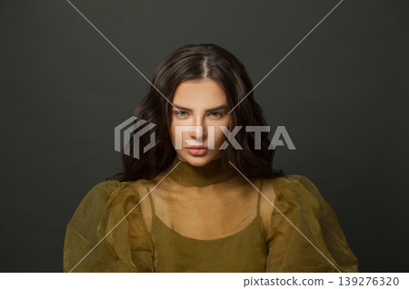 Woman in green organza sheer fabric traditionally made from silk. Beautiful model Woman in green organza sheer fabric traditionally made from silk. Beautiful model 139276320