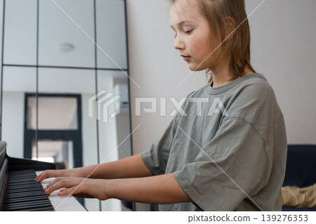 Happy teen boy enjoy playing practicing electronic piano keyboard Happy teen boy enjoy playing practicing electronic piano keyboard 139276353