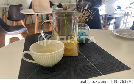 teapot and cup of tea on the table teapot and cup of tea on the table 139276359