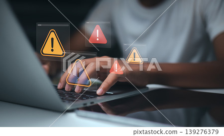 Cyber security warning on laptop screen,System error notification while working,Data breach alert digital icon overlays,Online fraud protection concept for business,Remote worker experiencing attack Cyber security warning on laptop screen,System error notification while working,Data breach alert digital icon overlays,Online fraud protection concept for business,Remote worker experiencing attack 139276379