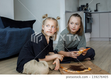 Happy friends girl and boy eating pizza at home Happy friends girl and boy eating pizza at home 139276405