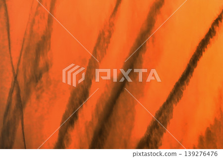Traces airplane air trail jet line stripe sunset orange sky background Traces airplane air trail jet line stripe sunset orange sky background 139276476