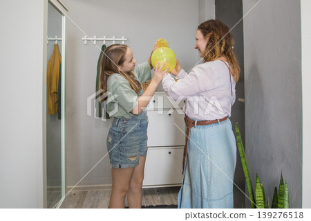 Mom and daughter stand at the entrance of a modern apartment. Mom and daughter stand at the entrance of a modern apartment. 139276518