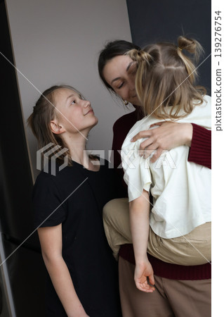 Happy family indoor portrait. Mother, son and daughter. Happy family indoor portrait. Mother, son and daughter. 139276754