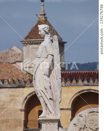 Raphael Archangel stone statue in the Roman Bridge of Cordoba, Spain. 139276786