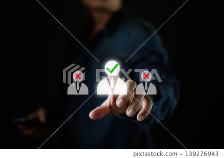 A person selects a highlighted candidate icon with a green check mark among others marked with red crosses, symbolizing recruitment,candidate selection,and target marketing in a digital interface. 139276943