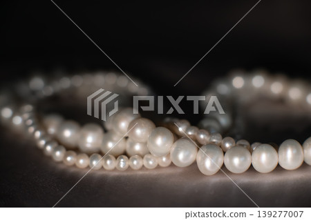 Pearl necklace strands on soft gray background, bridal elegance concept. 139277007