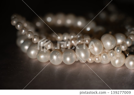 Luxury pearl strands on gray background, elegant jewelry texture. Luxury pearl strands on gray background, elegant jewelry texture. 139277009