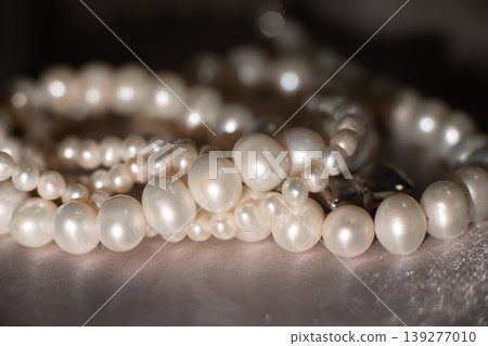 Pearl strands on gray background, luxury jewelry texture with elegant composition. 139277010