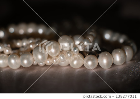 Elegant pearl strands arranged on neutral background, symbol of luxury and refinement. 139277011