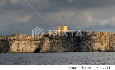 Cliffs of the coast with partially old fortress view in Comino island Cliffs of the coast with partially old fortress view in Comino island 139277118