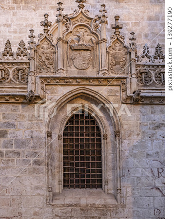 Ornate Gothic Stone Window With Coat of Arms and Intricate Carvings on Historic Royal Chapel of Granada Ornate Gothic Stone Window With Coat of Arms and Intricate Carvings on Historic Royal Chapel of Granada 139277190
