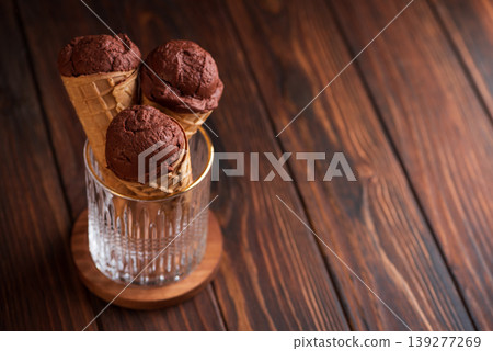 Chocolate Ice Cream Cones on Dark Wooden Background Chocolate Ice Cream Cones on Dark Wooden Background 139277269