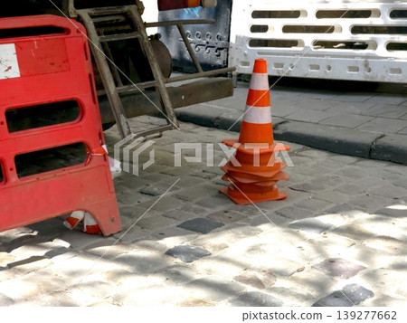 Fencing Set up for Road Repairs Near the Construction Site on a Sunny Day Fencing Set up for Road Repairs Near the Construction Site on a Sunny Day 139277662