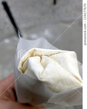 Enjoying a Wrap of Kebab and Shawarma on a Busy Street During Lunch Hour Enjoying a Wrap of Kebab and Shawarma on a Busy Street During Lunch Hour 139277670