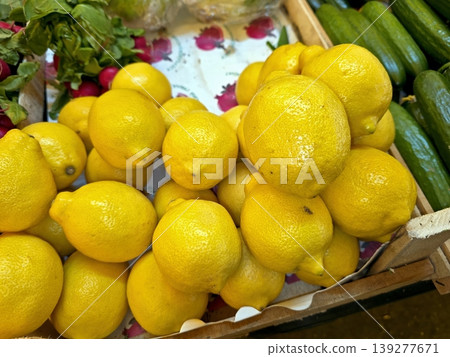 Fresh Lemons Are Stacked on a Counter at a Market Fresh Lemons Are Stacked on a Counter at a Market 139277671