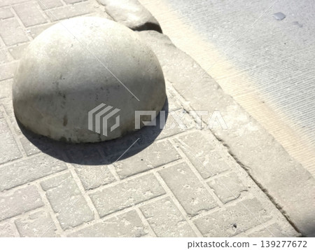 Pavement Section on Causeway With a Round Concrete Feature Beside the Edge Pavement Section on Causeway With a Round Concrete Feature Beside the Edge 139277672