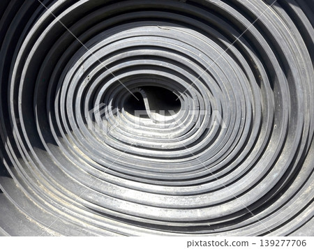 A Spiral Conveyor Belt Roll is Placed in a Factory Setting A Spiral Conveyor Belt Roll is Placed in a Factory Setting 139277706